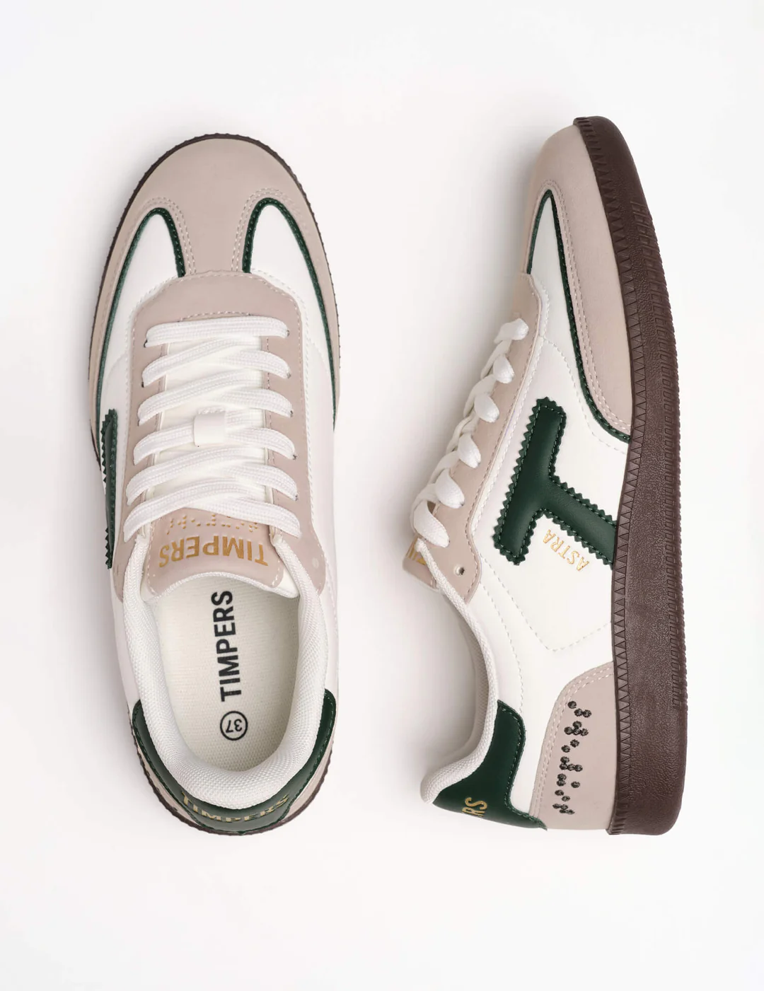 Beige and white trainers with a T in forrest green for Timpers and braille